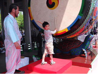 A boy beating the large drum