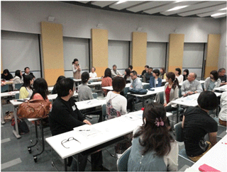 Participants listening to a presentation by an international student