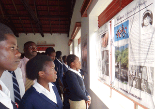 Visitors gaze seriously at the atomic bombing posters