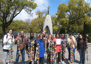 International students from International Christian University offering paper cranes at the Children's Peace Monument