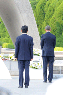 President Obama offers a silent prayer after laying a wreath