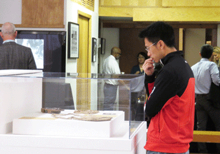 Visitor looking intently at A-bomb artifacts