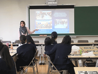 An intern explaining peace activities in Tehran City to young people from Hiroshima