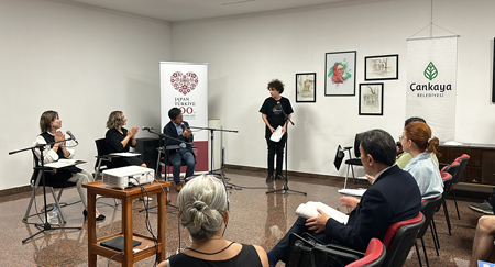 A participant tries reading in Japanese in front of a volunteer reader.
